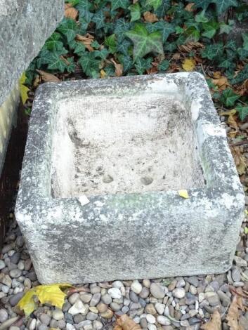 A square hewn stone trough or sink