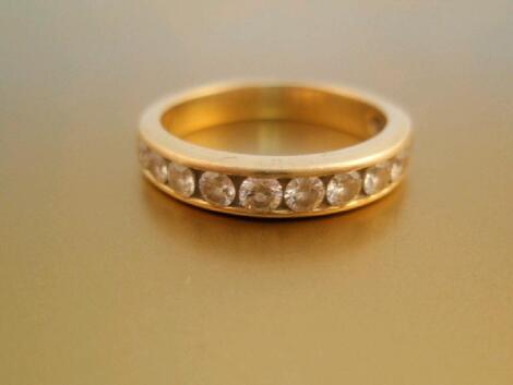 An 18ct gold half hoop eternity ring