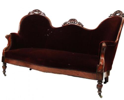 A Victorian carved mahogany double back spoon settee