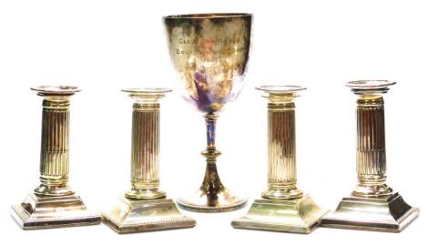 A set of four early 20thC classical design squat candlesticks