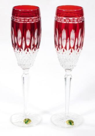 A pair of 20thC flash glass red and clear lead crystal ruby flutes