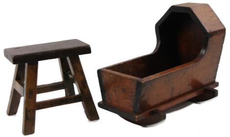 An late 19thC stained pine miniature doll's cradle