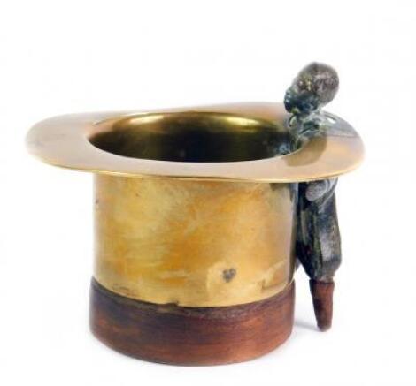 A late 19thC brass and wooden begging bowl modelled as a top hat