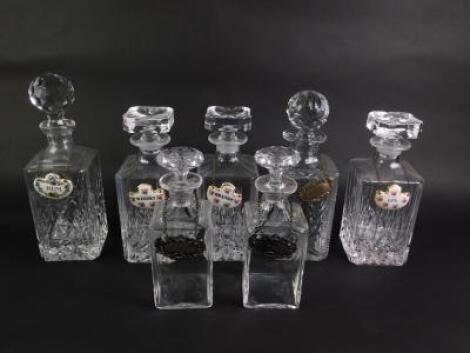 A set of three cut glass decanters