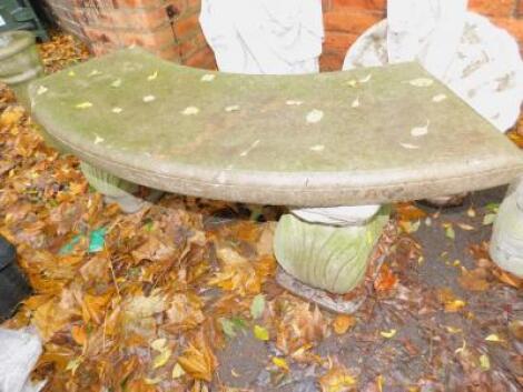 A concrete curved garden bench