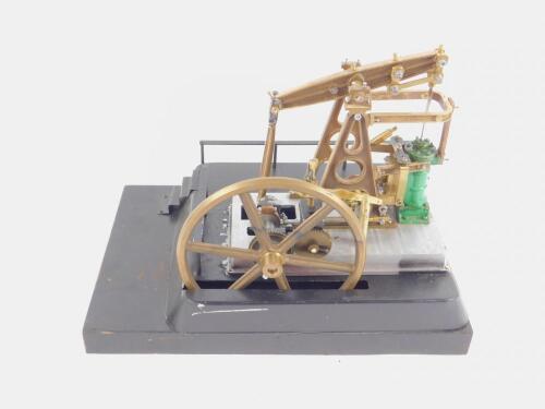 A steel and brass model of a pumpjack or nodding donkey