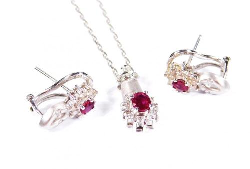 A white gold diamond and ruby necklace and earring set