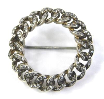 A circular bar brooch