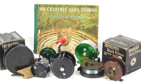 A collection of fishing reels etc.