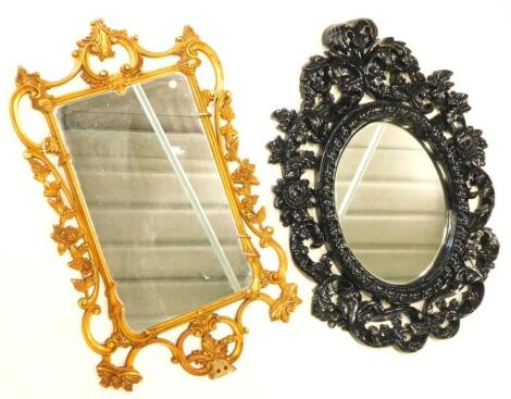 A black painted rococo scroll wall mirror