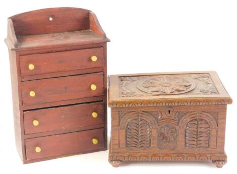 A miniature pine chest of four drawers