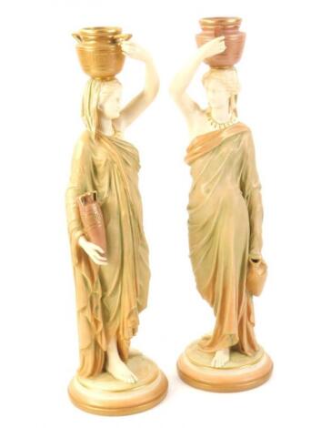 A pair of Royal Worcester porcelain water carriers