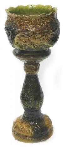 An Art Nouveau style pottery jardiniere and stand