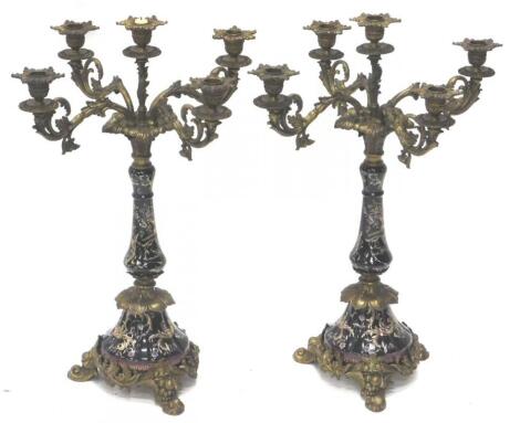 A pair of Continental porcelain and gilt metal five branch candelabra