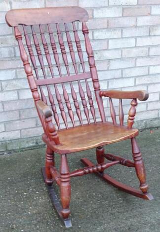 A 19thC spindle back rocking open armchair