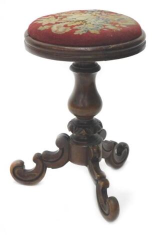 A Victorian walnut piano stool