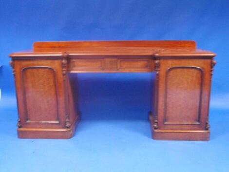 A Victorian mahogany inverted breakfront mahogany sideboard with central