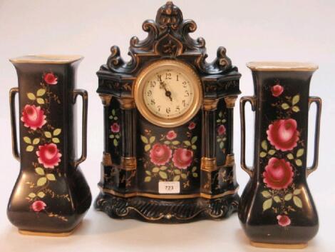 A Falcon ware black ground rose sprigged large ceramic clock and two vases