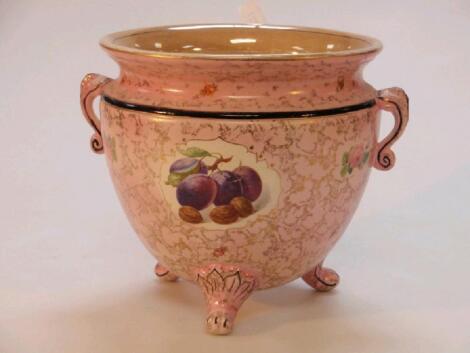 A large footed planter decorated in pink background with fruit