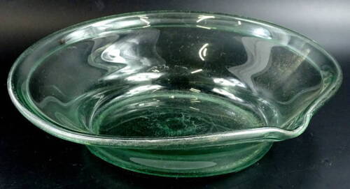 A late 19th/early 20thC kitchen or dairy cream bowl or dish, with a single lip and fold over rim, 45cm diameter.