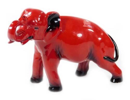 A Royal Doulton flambé elephant, with trunk raised, printed mark, 15cm H.