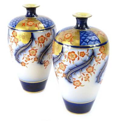 A pair of MacIntyre Aurelian ware Imari coloured vases, each decorated in Art Nouveau style with flowers, leaves etc., in iron red and gold, with underglazed blue, printed mark to underside, pattern number 19207/78, 21cm H (AF).