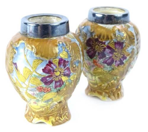 A pair of MacIntyre miniature vases, each decorated with flowers within raised gilt leafy borders, silver plated collars, printed mark in brown to underside, indistinct number 1908 and registration number 786895, 7cm H.