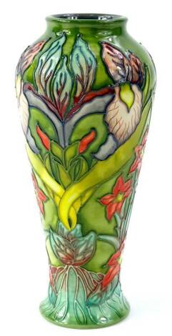 A Moorcroft trial vase, decorated with orchids and exotic flowers on a green ground, signed Philip Robinson to underside, dated 25.11.00, impressed Moorcroft mark, 20cm H.