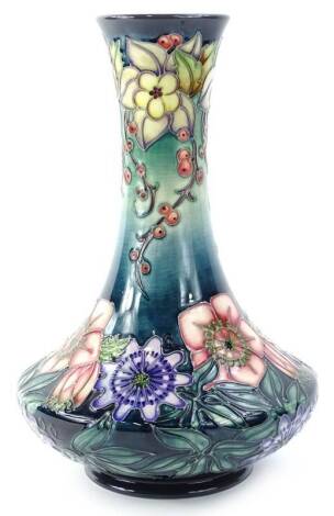 A Moorcroft Centenary year Carousel range bottle shaped vase, decorated with columbine, redcurrants, hellebore and passion flowers, designed by Rachel Bishop, numbered edition 369, with tube lining by Karen Gibson, paintress Sue Poynton, a second 33cm H.