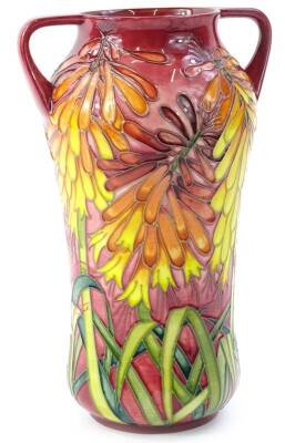 A Moorcroft two handled trial vase, decorated with brightly coloured orange, red, pink flowers, with leaves, various marks to underside to include Jeanne McDougall etc., dated 13.6.00, 27cm H.