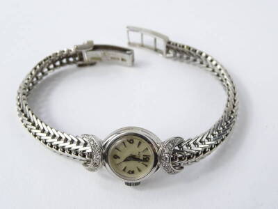 A ladies Rotary white metal and diamond wristwatch, stamped 750, 24.8g. - 2