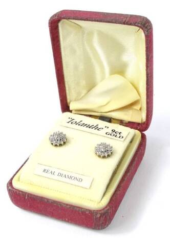 A pair of 9ct gold diamond set stud earrings, each stud set with three layers of tiny diamonds, 5mm W, in fitted case.