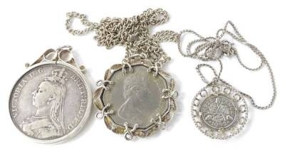 Modern silver coin necklaces, to include a silver plated 50 pence piece pendant and chain, a 1889 Victorian silver crown, in silver pendant, and a six pence piece in frame with later chain. (3)