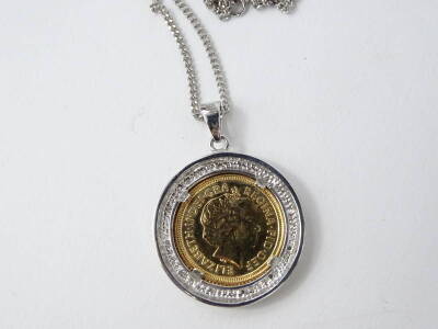 A half gold sovereign pendant, in a 9ct white gold frame, set with tiny paste stones, on fine link chain, the coin marked 2002, 12.9g all in. - 2