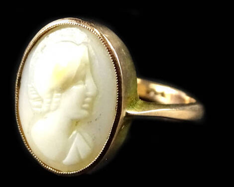 A 9ct gold cameo set dress ring, the oval cameo set with lady looking right, with hair piece, in moulded frame, 2.7g all in.