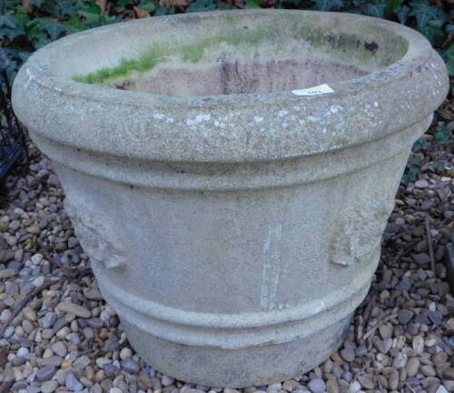 A composition garden urn or planter, cast with flower heads etc, 56cm diameter.