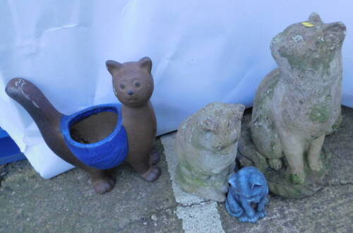 A collection of garden cat ornaments, to include an example with a central planter, and a large cat previously painted, 47cm H.