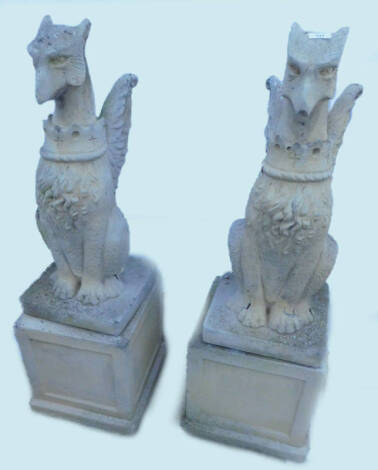 A pair of composition heraldic griffin garden ornaments, each on a square plinth, 112cm H.