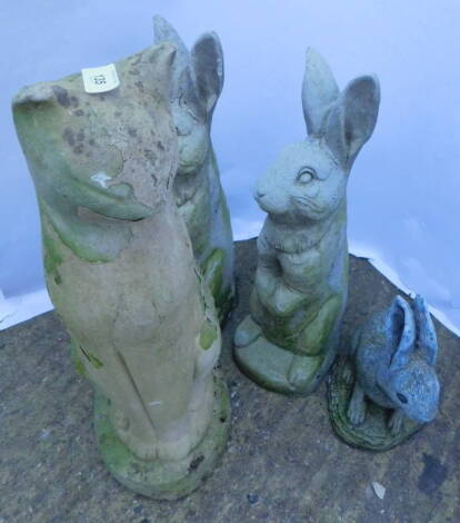 Four composition garden ornaments, three rabbits and a cat, the largest 59cm H.