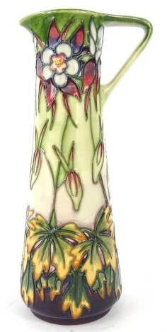 A Moorcroft Aquilegia pattern ewer, decorated with flowers and leaves on a mottled cream and green ground, designed by Philip Gibson, tube-lined by Julie Harrison, paintress Debbie Hancock, limited edition 111 of 250, handwritten and impressed marks to un