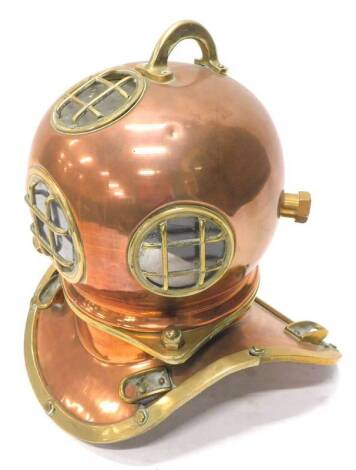 A copper and brass diver's helmet, with glazed circular sections, unmarked, 46cm W.