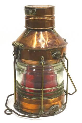 A copper and brass ship signalling lantern, with moulded glass lens, stamped Not Under Command, 48cm H.