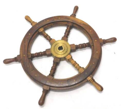 A hardwood and brass small ships wheel, with turned spokes and handles, 62cm diameter.