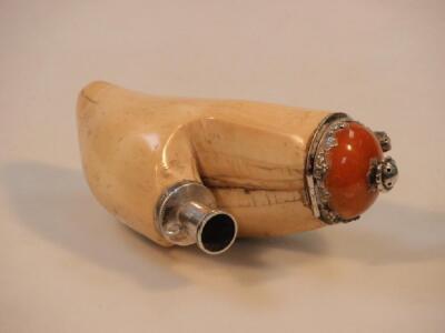 An antique whale tooth pipe