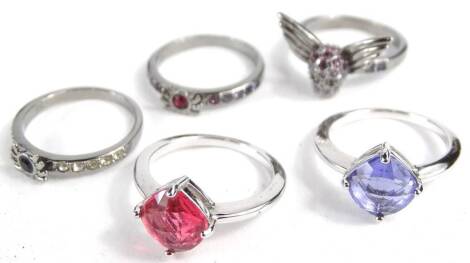 A collection of five Swarovski crystal dress rings, to include a skull with wings, two with coloured rectangular crystals inset, etc.