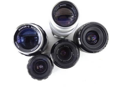 A collection of camera lens, to include a Nikon 135mm, a Nikon 55mm, a Canon 70mm, and a 135mm lens. - 2