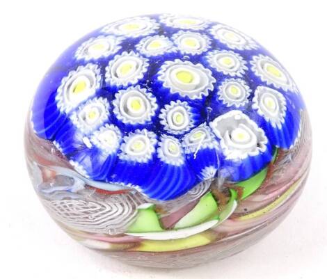 A Venetian style paperweight, with blue, yellow and white canes, and scrambled base, 8.5cm diameter.