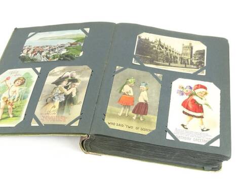 An album of early 20thC postcards, to include some First World War silk, some amusing, military, real photo etc.