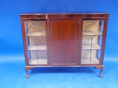 An early 20thC mahogany display cabinet with moulded and serpentine front