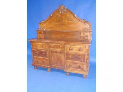 A Victorian pine dresser with shaped back